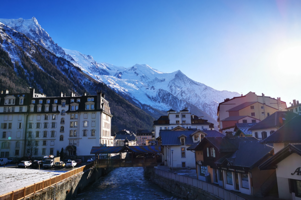 The town of Chamonix in French with a snow capped mountain behind it